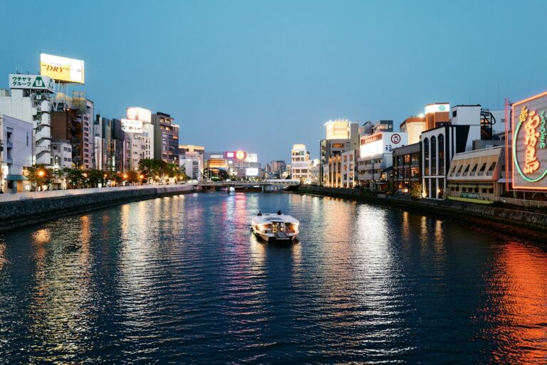明太子與福岡 white boat on river near city buildings during daytime