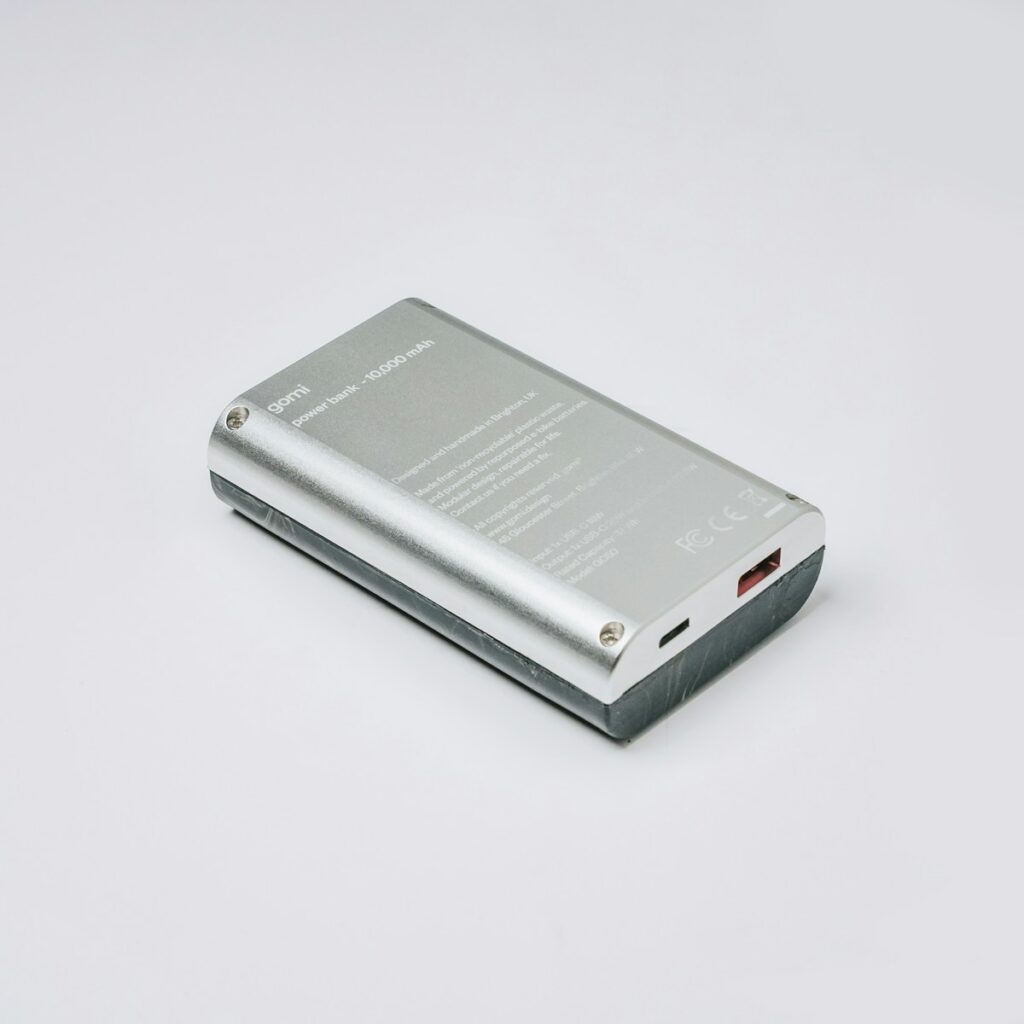 行動電源登機新規定 a silver electronic device sitting on top of a white table
